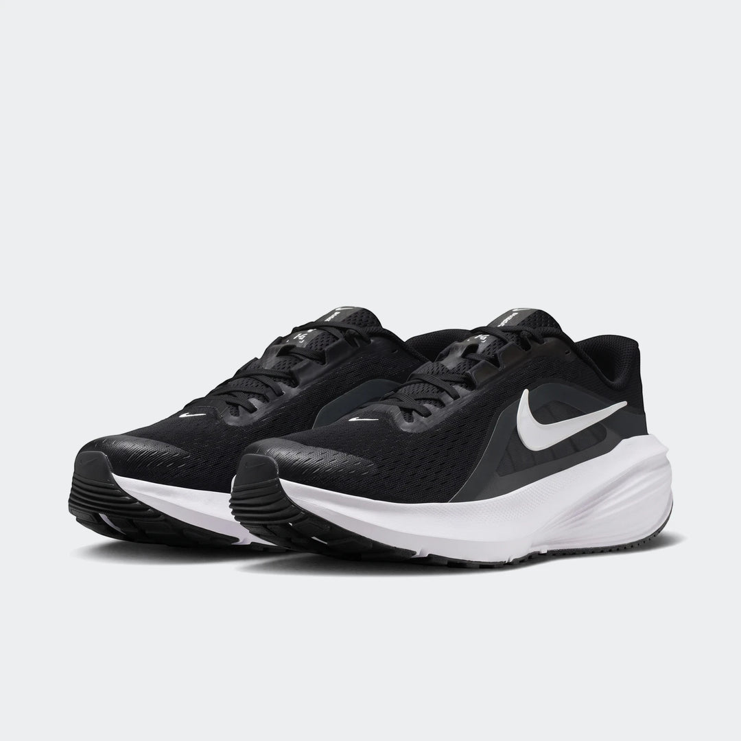Pair of Nike Downshifter 14 men's road running shoes in black with white soles and swoosh, angled view.
