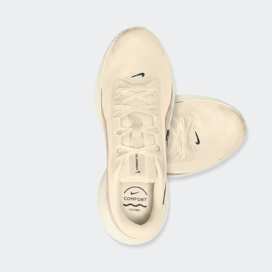 Top-down view of a Nike Downshifter 14 Men's Road Running Shoe in cream and white, designed for comfort.