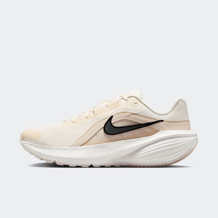 Nike Downshifter 14 men's road running shoe in off-white, featuring a black swoosh, mesh upper, and sculpted sole, viewed