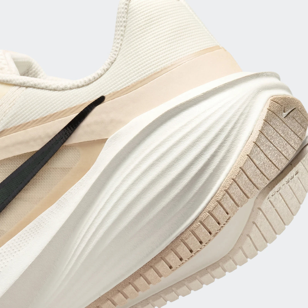 Close-up of Nike Downshifter 14 White Men's Road Running Shoe showing the side profile with midsole and outsole details.
