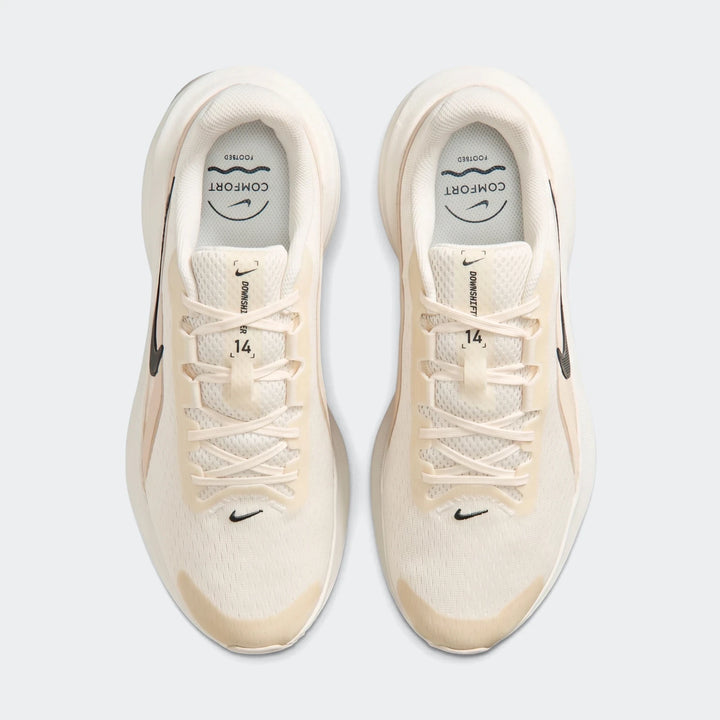 Nike Downshifter 14 white men's road running shoes, top-down view. Cream and off-white with black swoosh logos and laces.