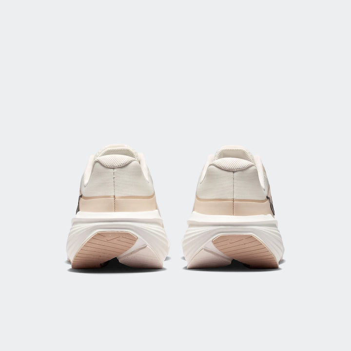 Rear view of Nike Downshifter 14 men's road running shoes in white and beige, showcasing the heel and sole design.