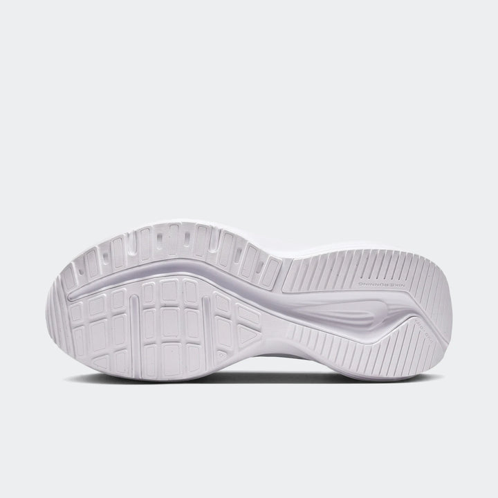 Nike Downshifter 14 white sneakers shown from the bottom, featuring a textured rubber outsole with grip pattern.