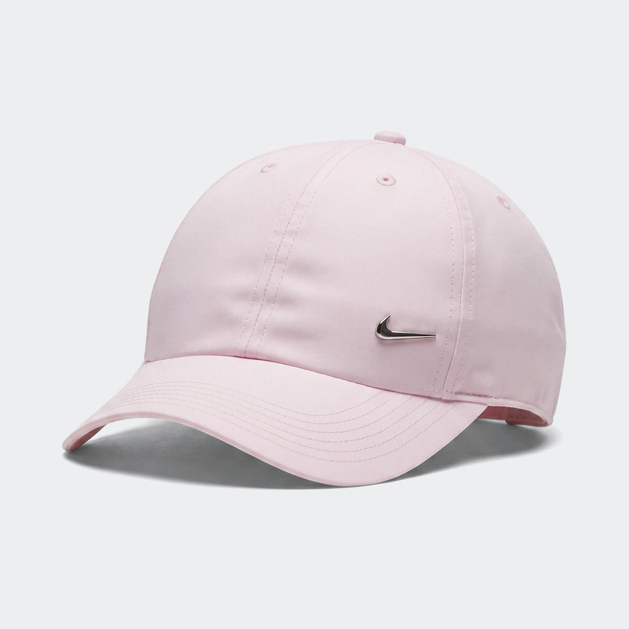 Light pink Nike Dri-Fit Club baseball cap with a silver metallic swoosh logo on the front, captured in a product shot.