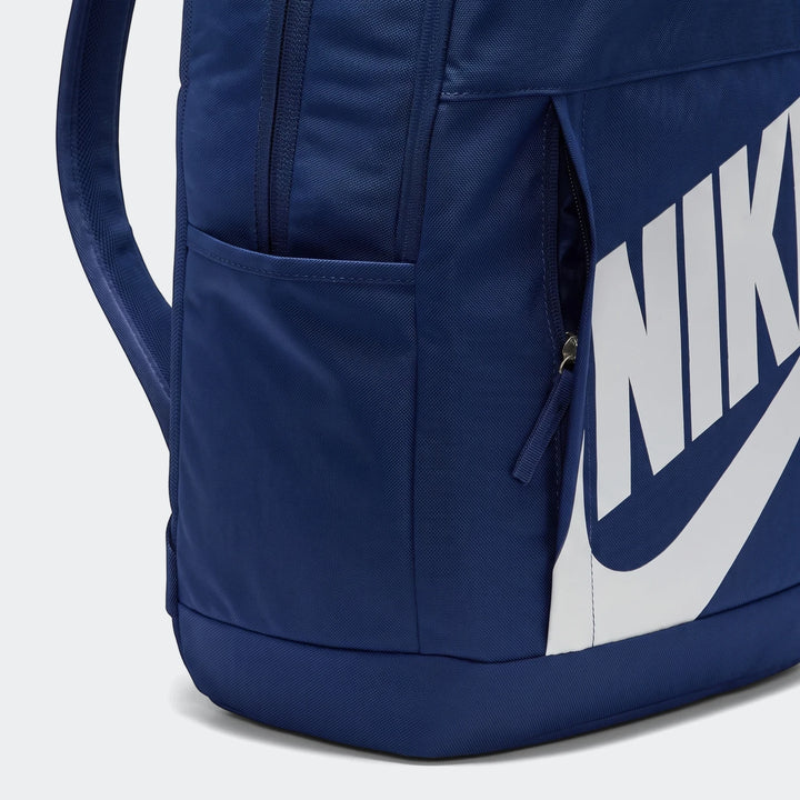 Close-up view of a blue Nike Elemental Backpack (21L) featuring a main compartment, side zippered pocket, and white Nike