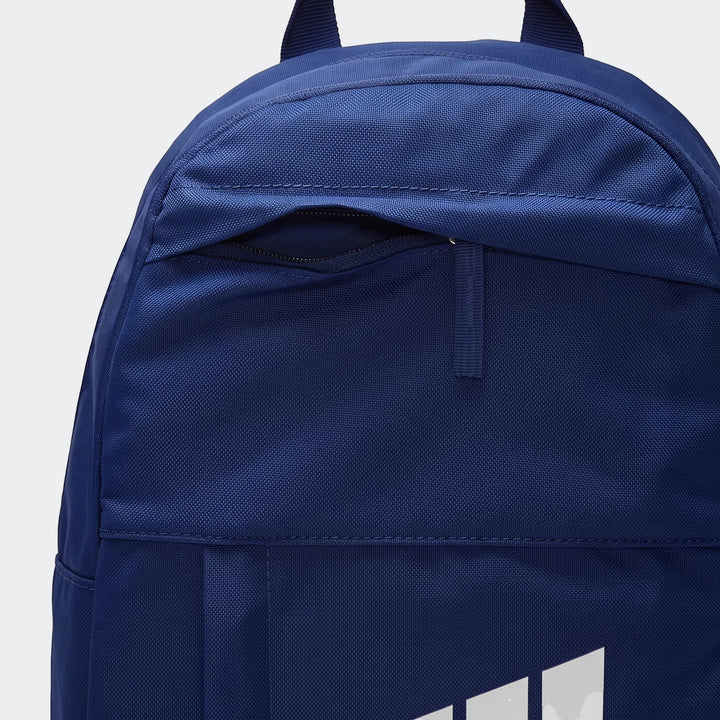 Close-up view of a blue Nike Elemental backpack, showing the zippered front pocket and part of the white logo.