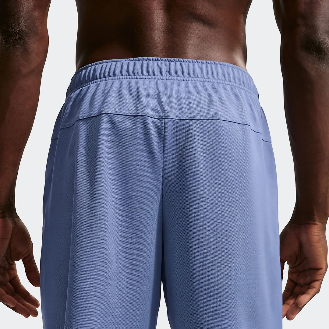 Back view of blue Nike Flex Men's Dri-Fit 7-inch training shorts worn by a model, highlighting fabric texture and waistband.