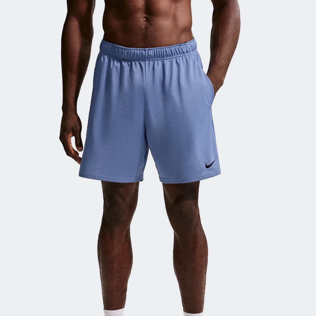 Blue Nike Flex Men's Dri-Fit 7 inch training shorts shown on a model, featuring side pockets and a black swoosh logo.
