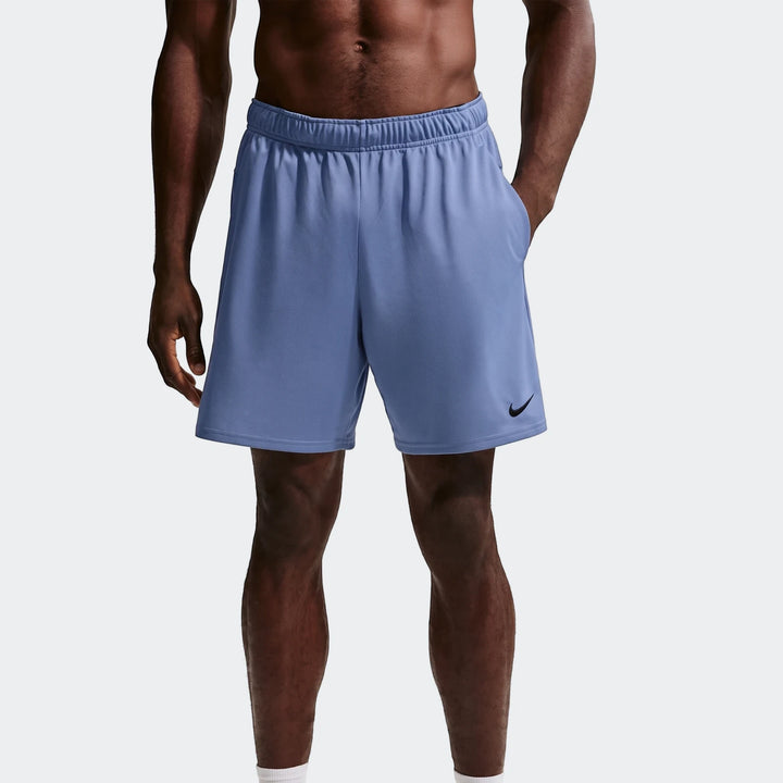 Blue Nike Flex Men's Dri-Fit 7 inch training shorts shown on a model, featuring side pockets and a black swoosh logo.