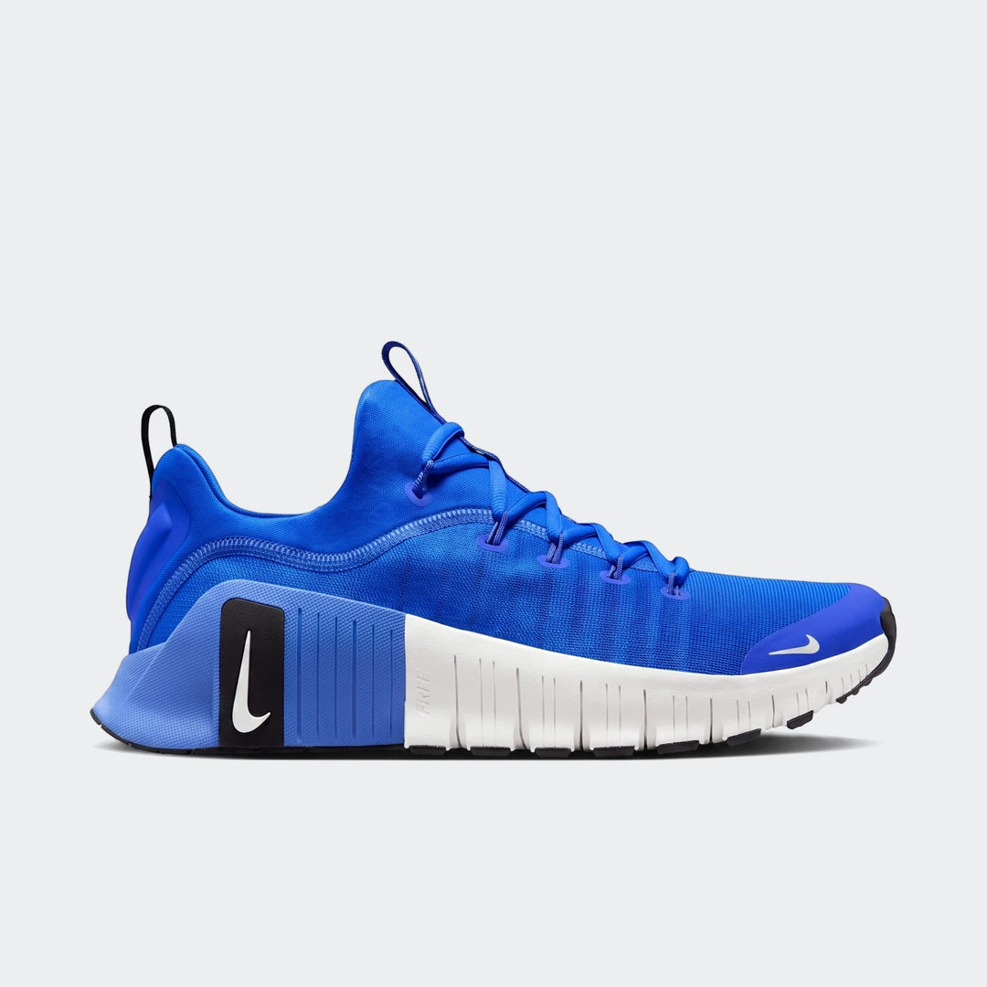 A single Nike Free Metcon 6 sneaker in vibrant royal blue and white, showcasing its athletic design and segmented sole. Side
