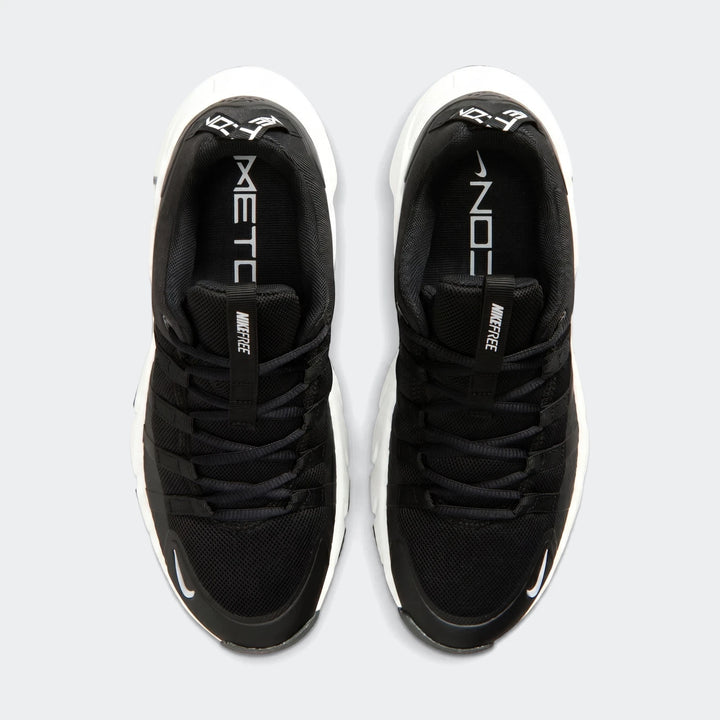Top-down view of two black Nike Free Metcon 7 women's training shoes with white soles and branding.