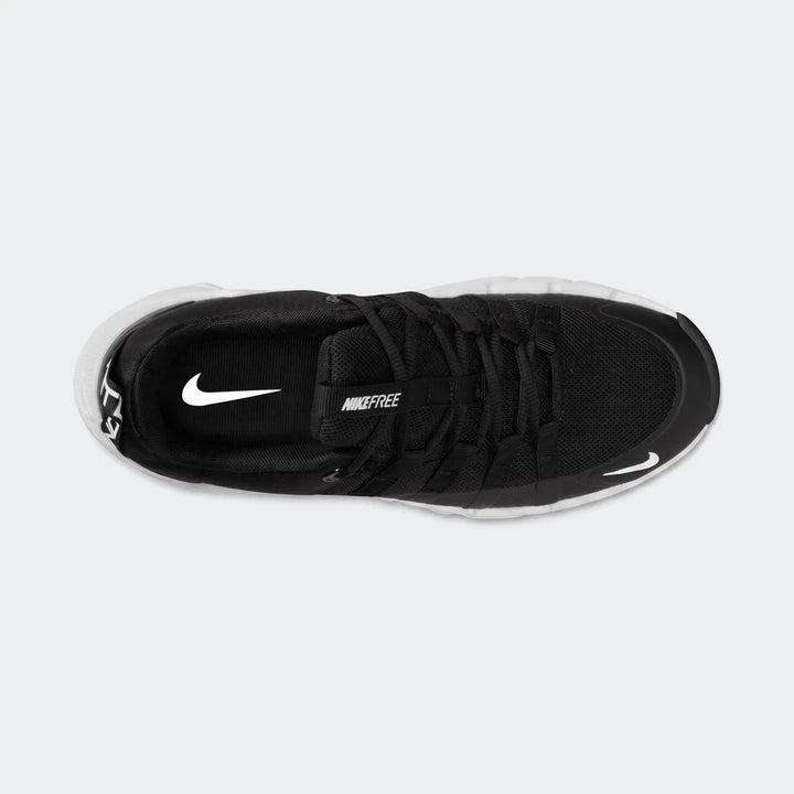 Top-down view of a black Nike Free Metcon 7 women's training shoe with a white sole, featuring Nike swoosh logos and