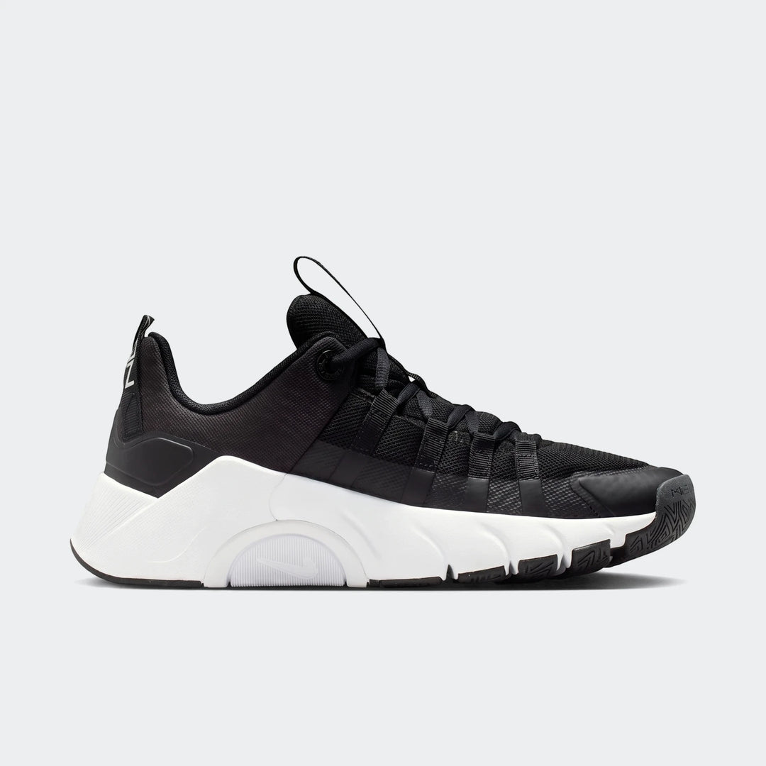 Nike Free Metcon 7 women's training shoe in black and white, with a mesh upper, thick white sole, and prominent Nike logo,