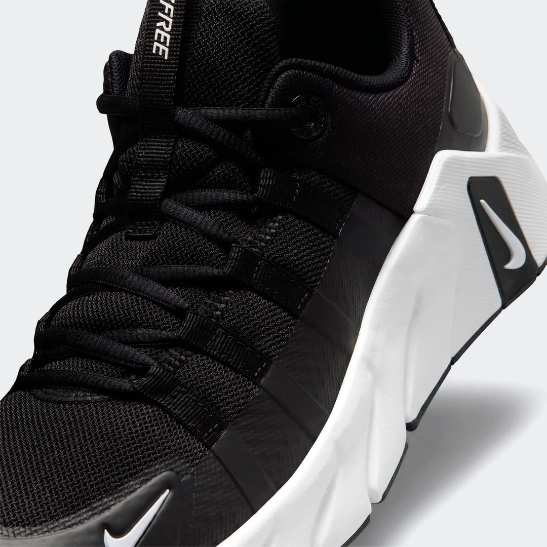 Close-up of a black Nike Free Metcon 7 women's training shoe, showing the mesh upper, white sole, and Nike swoosh.