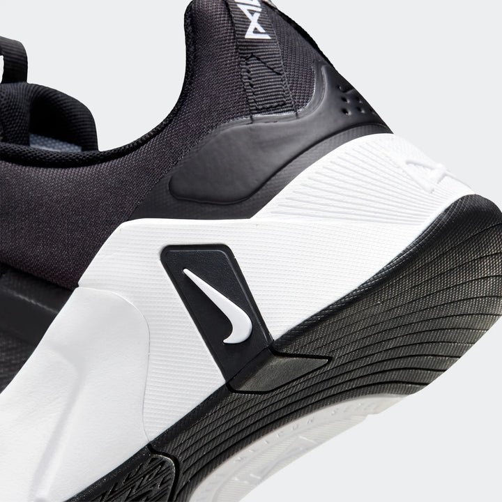 Close-up of the heel of a black and white Nike Free Metcon 7 women's training shoe, featuring white midsole and black mesh