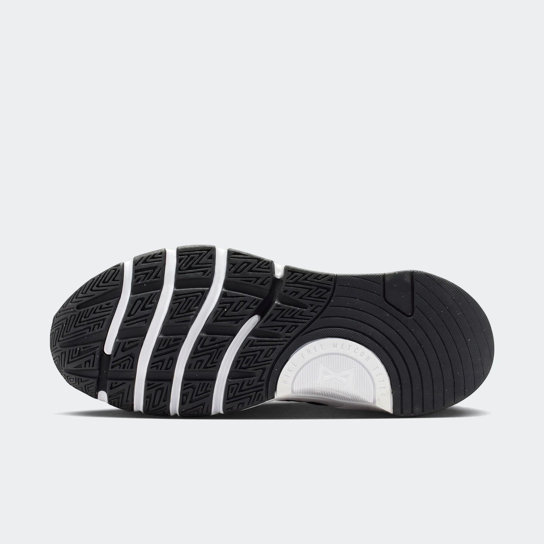 Nike Free Metcon 7 women's training shoe in black and white, featuring a detailed view of the textured sole.