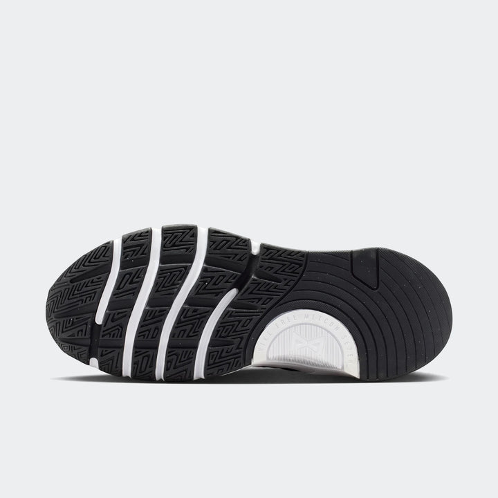 Nike Free Metcon 7 women's training shoe in black and white, featuring a detailed view of the textured sole.