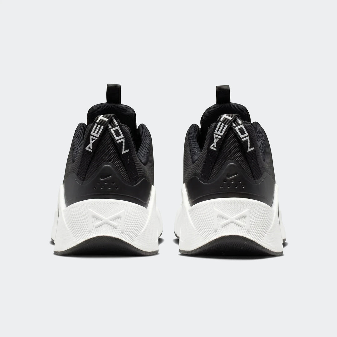 Rear view of Nike Free Metcon 7 women's training shoes in black with white soles and 'METCON' heel straps.