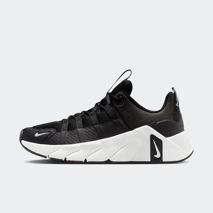 Nike Free Metcon 7 women's training shoes in black and white, shown in a side view on a white background.