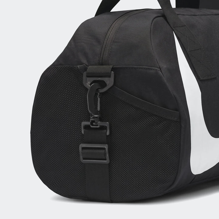Close-up of a black Nike Gym Club duffel bag showing a side mesh pocket, black strap with clasp, and partial white Nike logo.