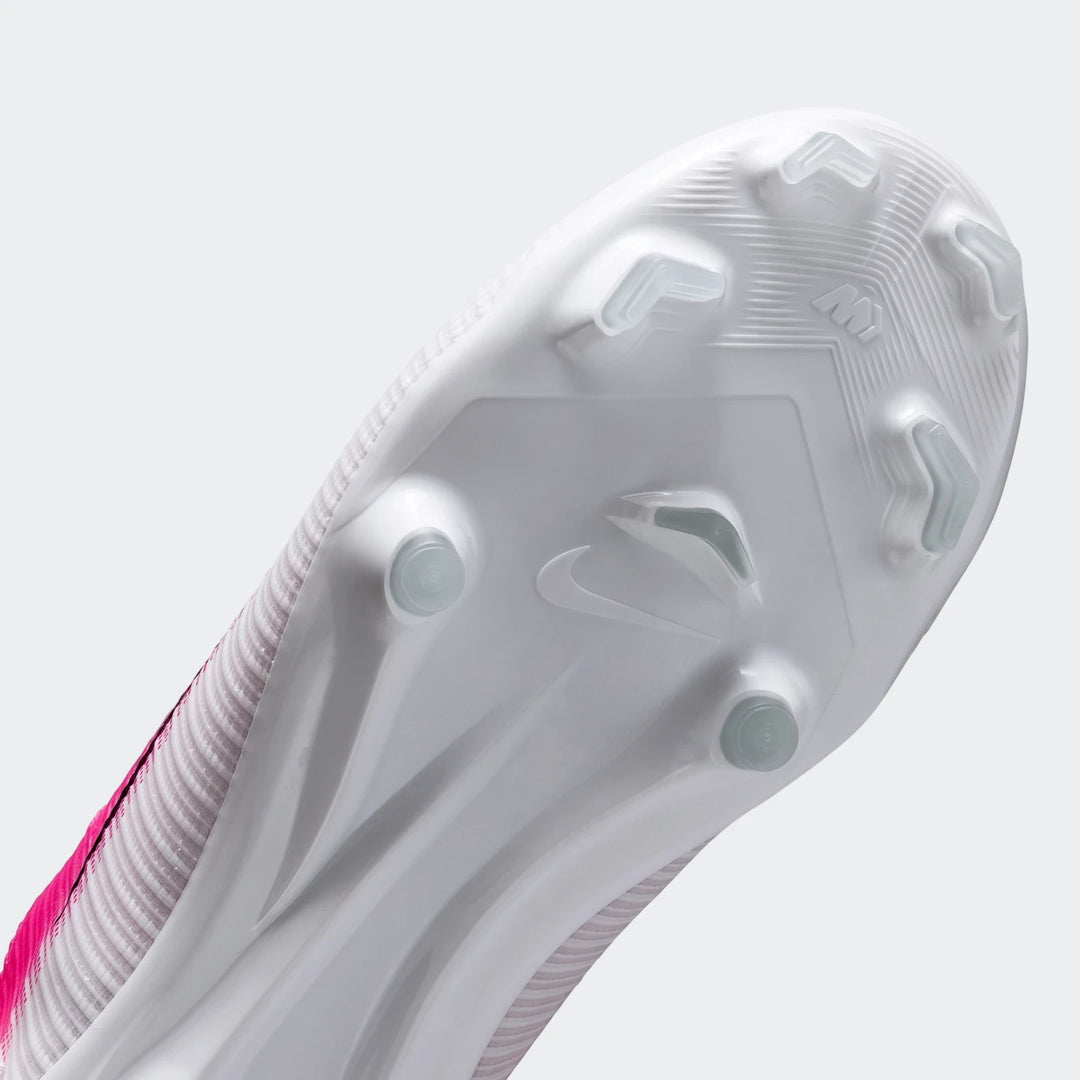 Sole view of a white and pink Nike Jr. Mercurial Vapor 17 Academy Big Kids' Multi-Ground Low-Top Soccer Cleat with