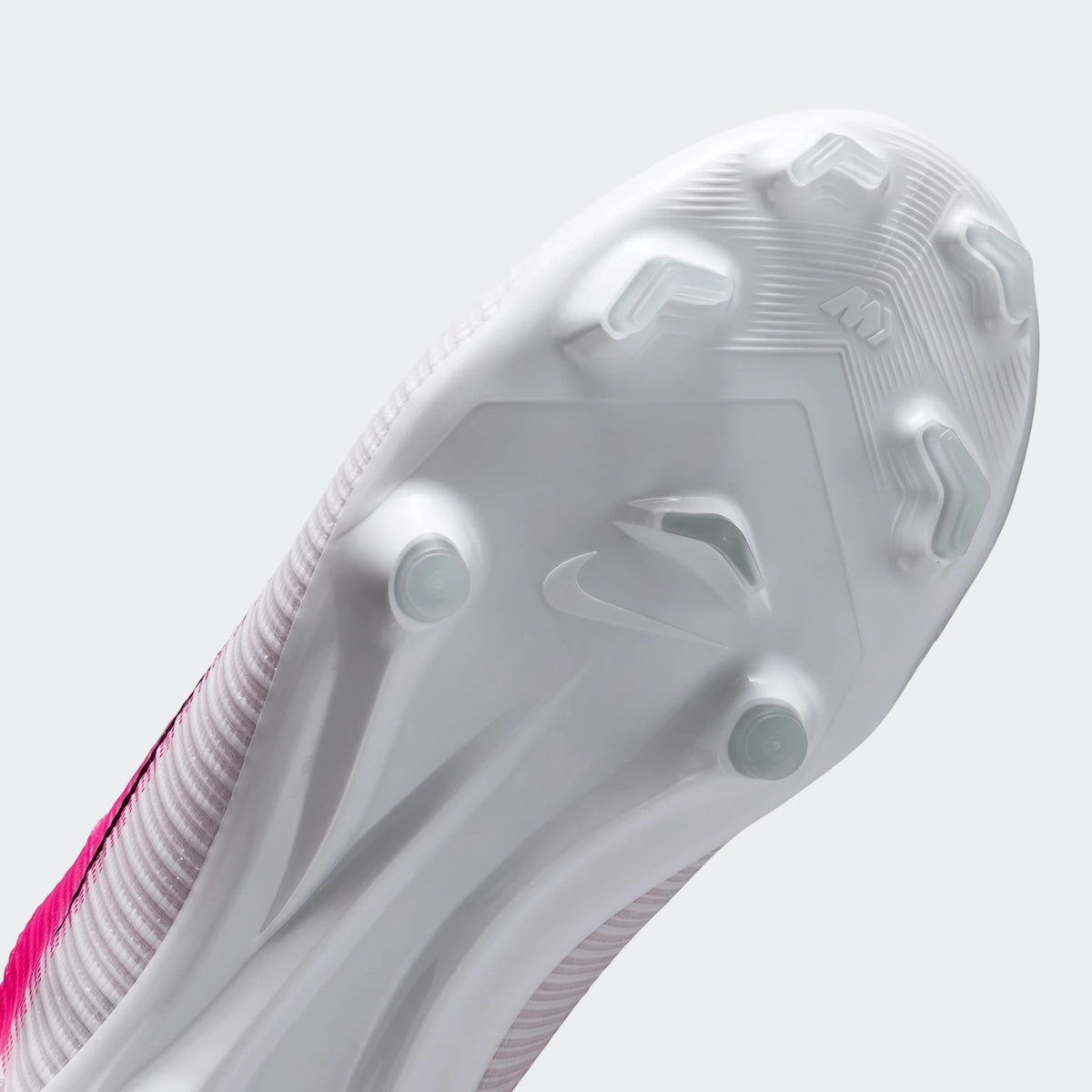 Sole view of a white and pink Nike Jr. Mercurial Vapor 17 Academy Big Kids' Multi-Ground Low-Top Soccer Cleat with