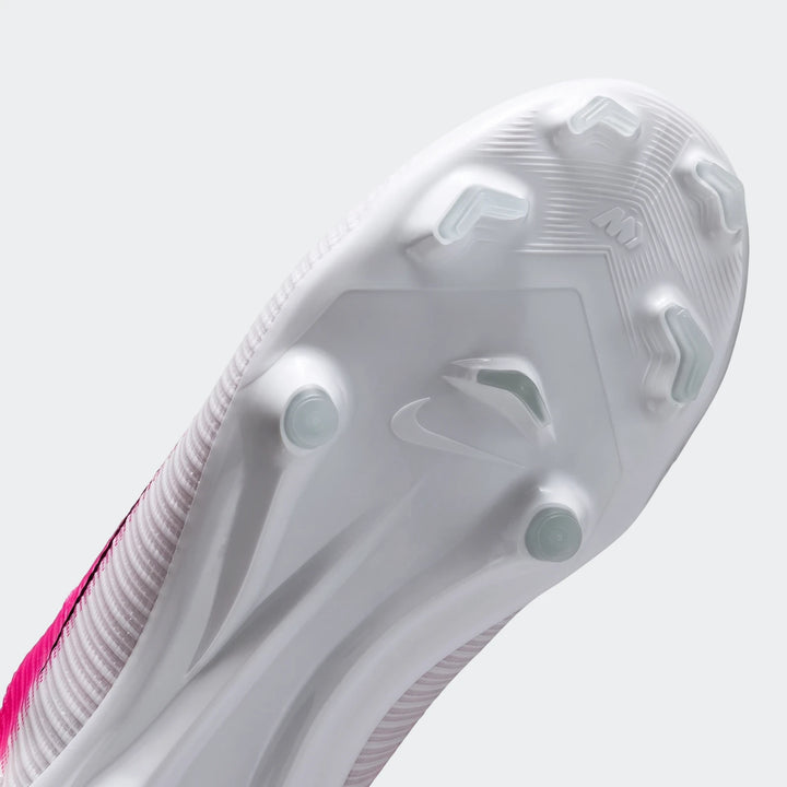 Sole view of a white and pink Nike Jr. Mercurial Vapor 17 Academy Big Kids' Multi-Ground Low-Top Soccer Cleat with