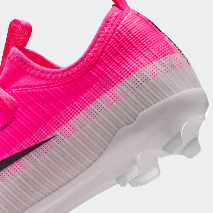 Close-up of Nike Jr. Mercurial Vapor 17 Academy Big Kids' Multi-Ground Low-Top Soccer Cleats in vibrant pink and white.
