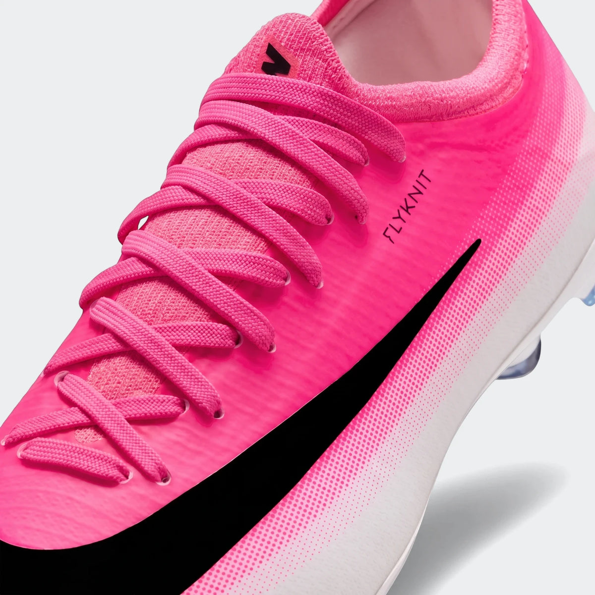 Close-up of a vibrant pink and white Nike Jr. Mercurial Vapor 17 Pro Big Kids' firm-ground low-top soccer cleat.