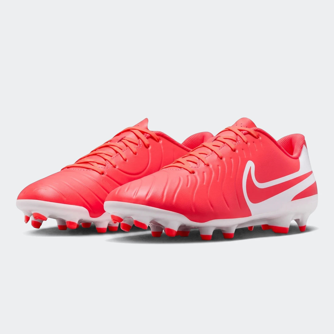 A pair of vibrant red Nike Legend 10 Club Fg/Mg soccer boots with white swoosh logos and white soleplates, displayed from a