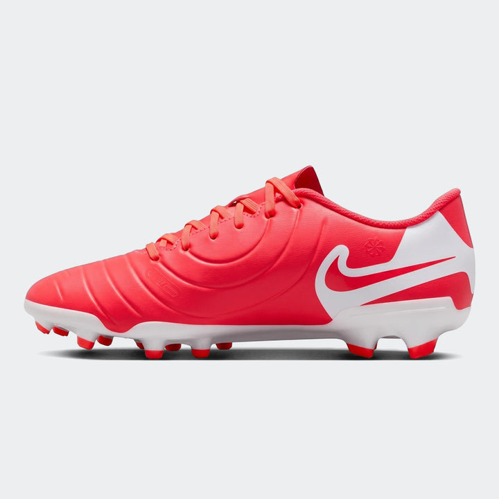 Nike Legend 10 Club Fg/Mg red and white soccer cleats, shown from the side with textured upper and conical studs.