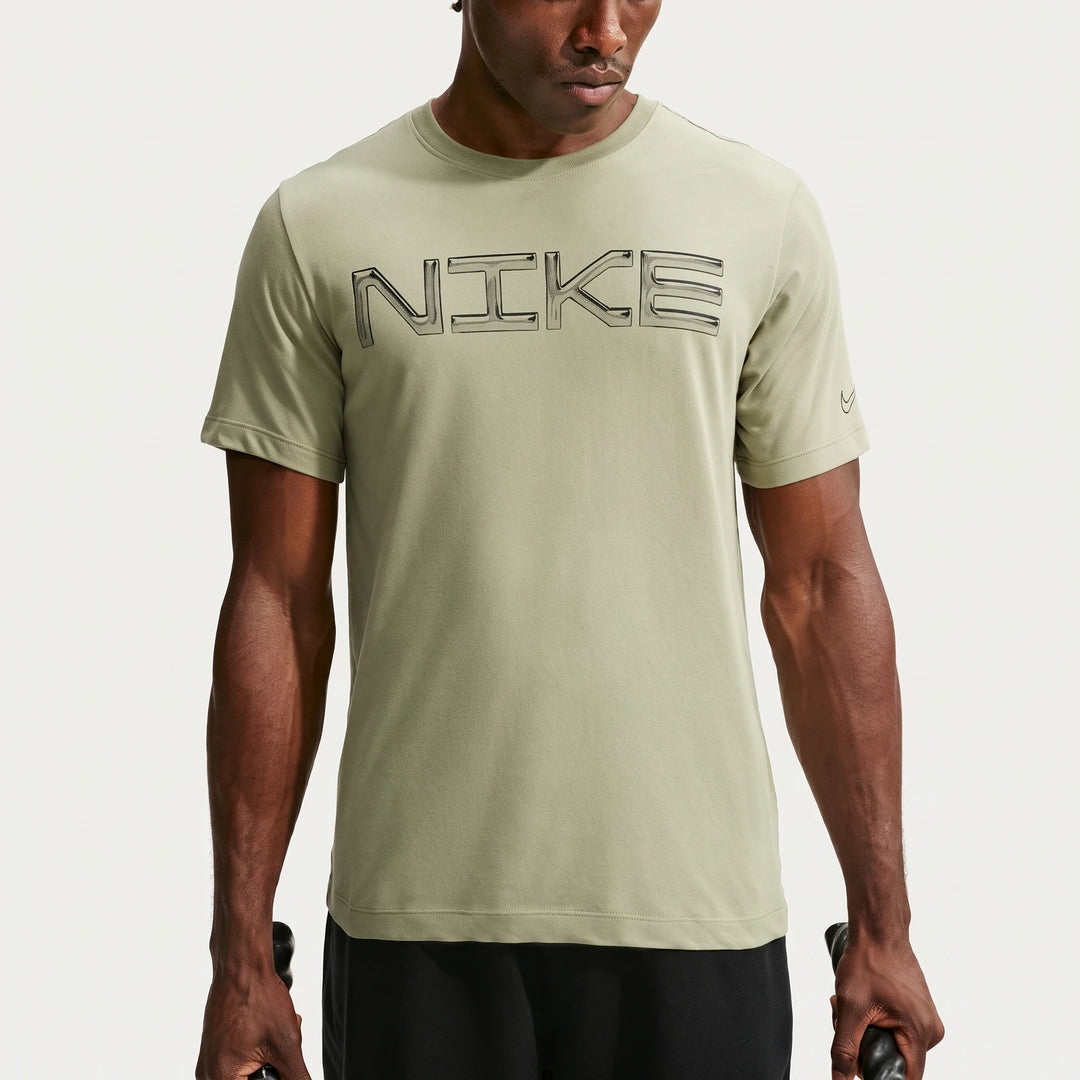 Light green Nike Men's Dri-Fit Training T-shirt with a prominent black Nike outline logo, worn by a male model.