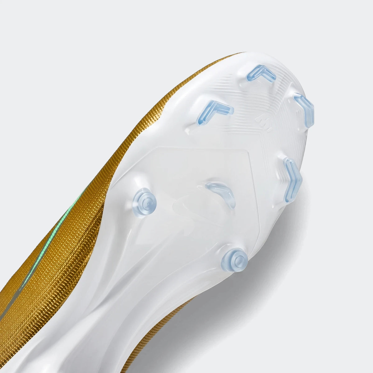 Nike Mercurial Superfly 11 Academy soccer cleat, gold and white, showing the sole with light blue multi-ground studs.