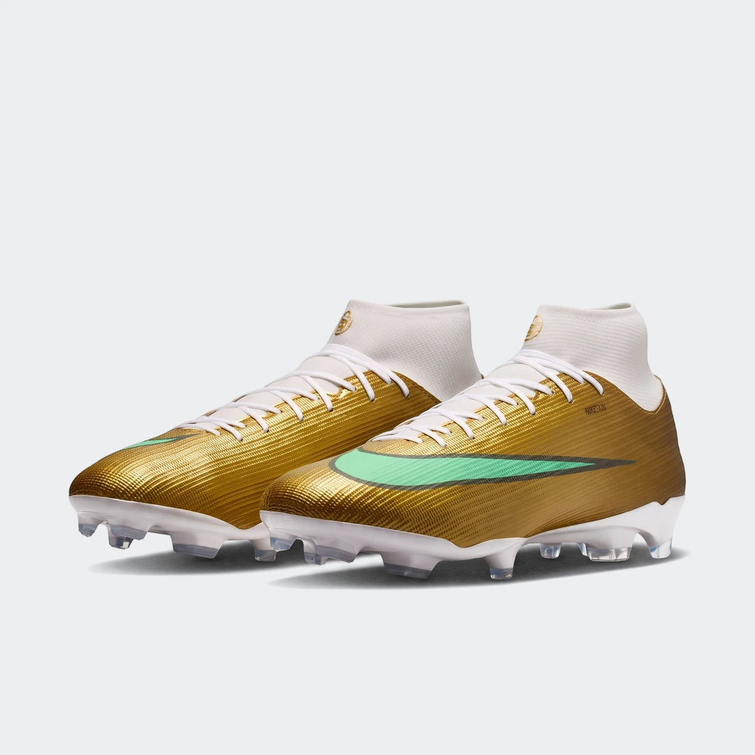 Pair of Nike Mercurial Superfly 11 Academy Kylian Mbappé multi-ground high-top soccer cleats in gold, mint green, and white.