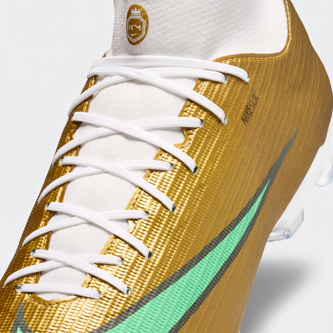 Close-up of Nike Mercurial Superfly 11 Academy Kylian Mbappé multi-ground high-top soccer cleats in gold, white, and mint