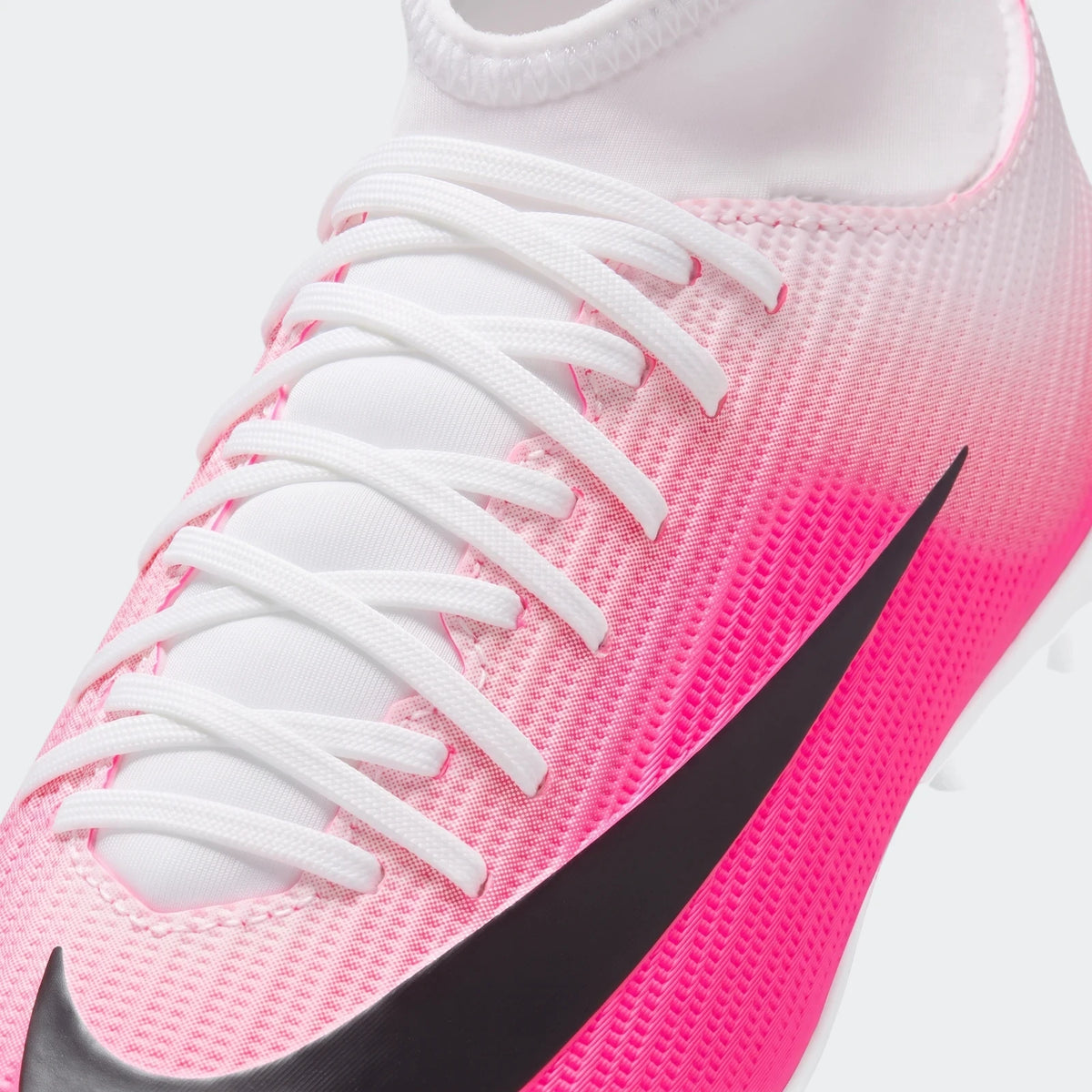 Close-up of a pink and white Nike Jr. Mercurial Superfly 11 Club Big Kids' Multi-Ground High-Top Soccer Cleat with white