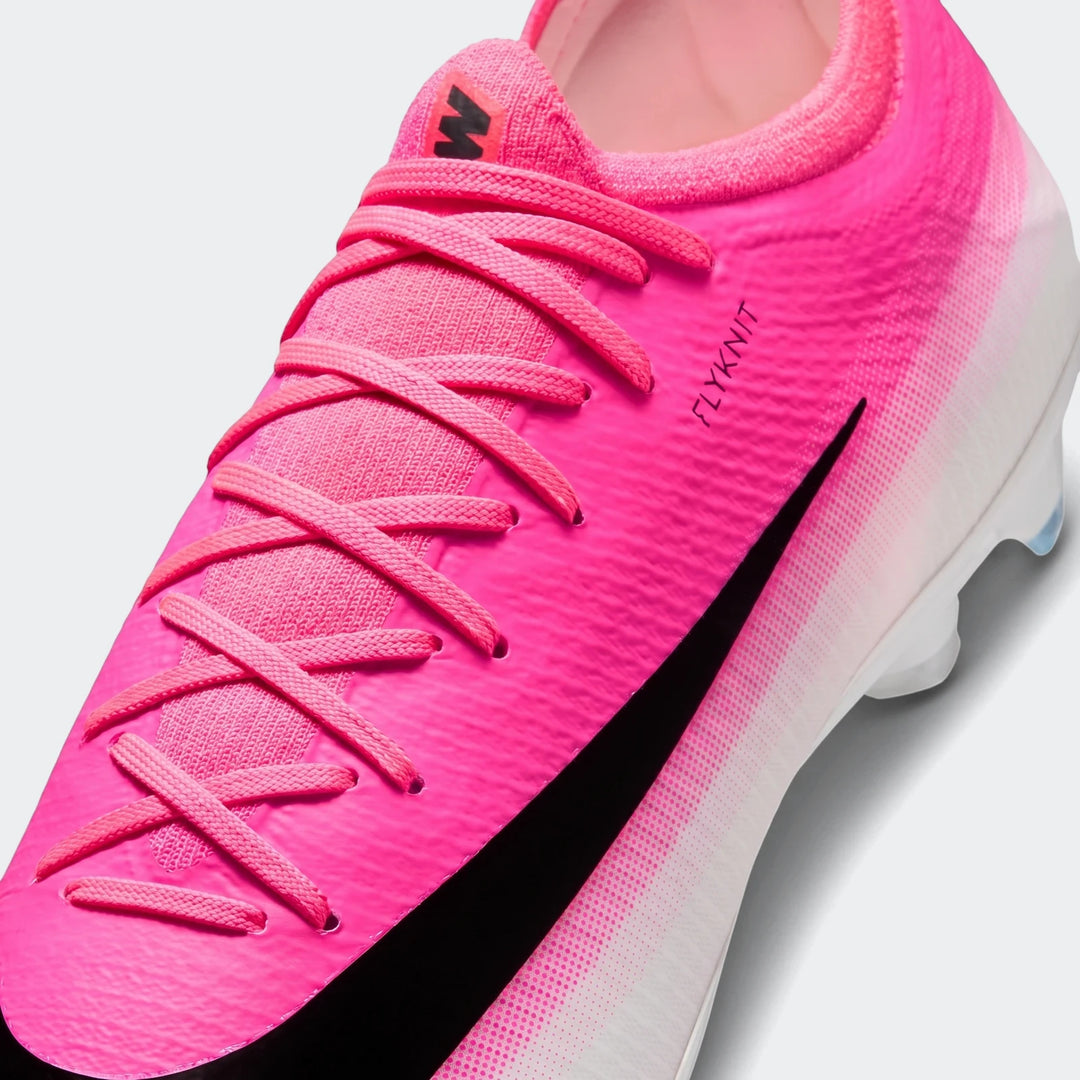 Close-up of a bright pink Nike Mercurial Vapor 17 Pro firm-ground soccer cleat with a black swoosh and "FLYKNIT" text.