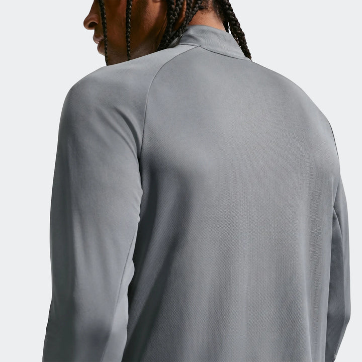 Close-up back view of a man wearing a grey Nike Miler Dri-Fit 1/2-Zip Running Top with raglan sleeves.