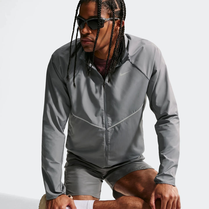 Nike Miler Grey Men's Repel UV Protection Running Jacket worn by a male model in a medium shot, featuring dreadlocks and