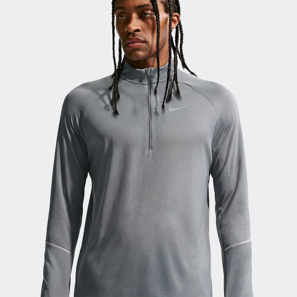 Grey Nike Miler Men's Dri-Fit 1/2-Zip Running Top modeled, highlighting its performance fabric and design.