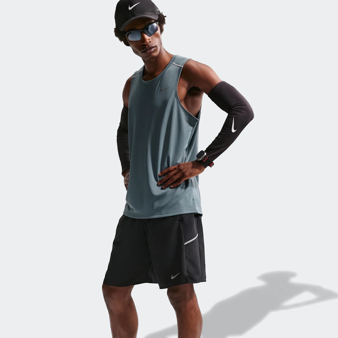 Nike Miler Men's Dri-Fit 9" Unlined Running Shorts in black, worn by a male model in a full athletic ensemble with a