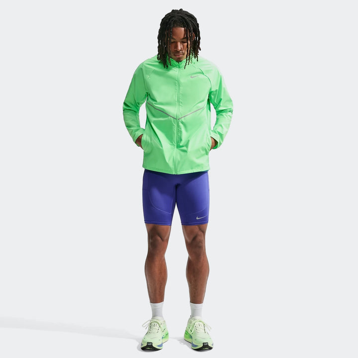 Lime green Nike Miler Men's Repel UV Protection Running Jacket worn by a male model, paired with purple shorts, full body