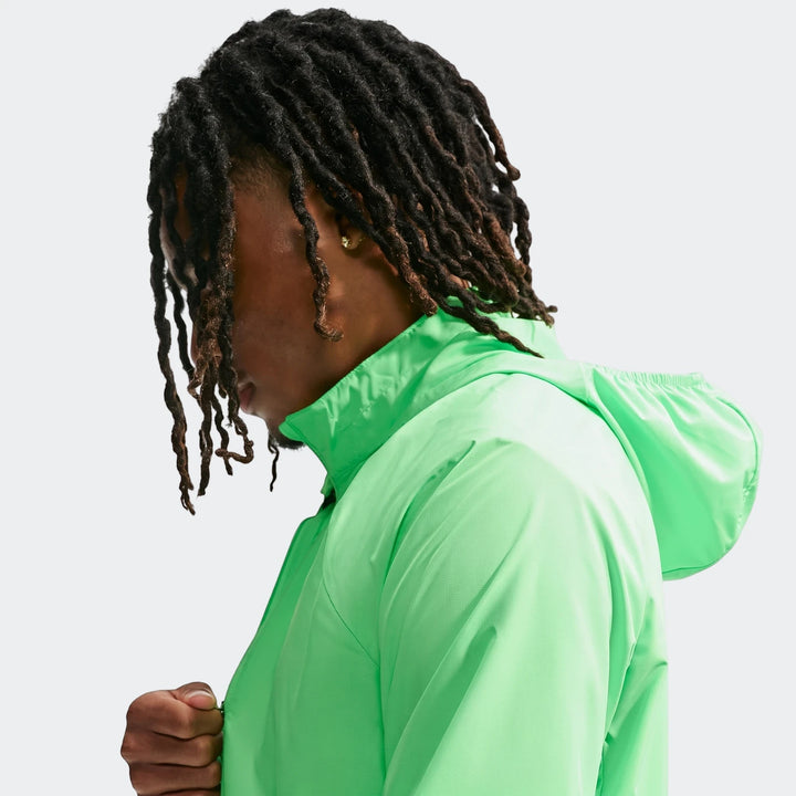 Close-up of a man wearing a bright neon green Nike Miler Repel UV Protection running jacket.