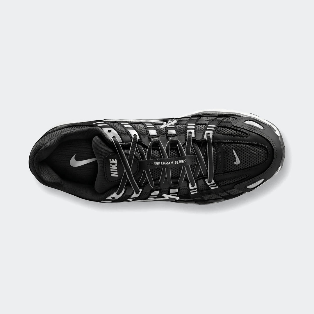 Top-down view of a black Nike P-6000 athletic shoe, featuring a mesh upper, white laces, and distinctive white accents.