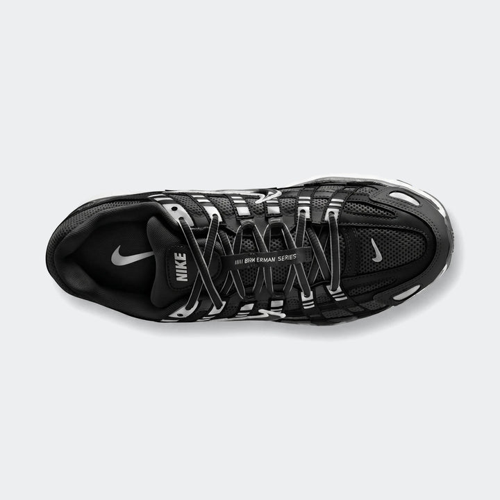 Top-down view of a black Nike P-6000 athletic shoe, featuring a mesh upper, white laces, and distinctive white accents.