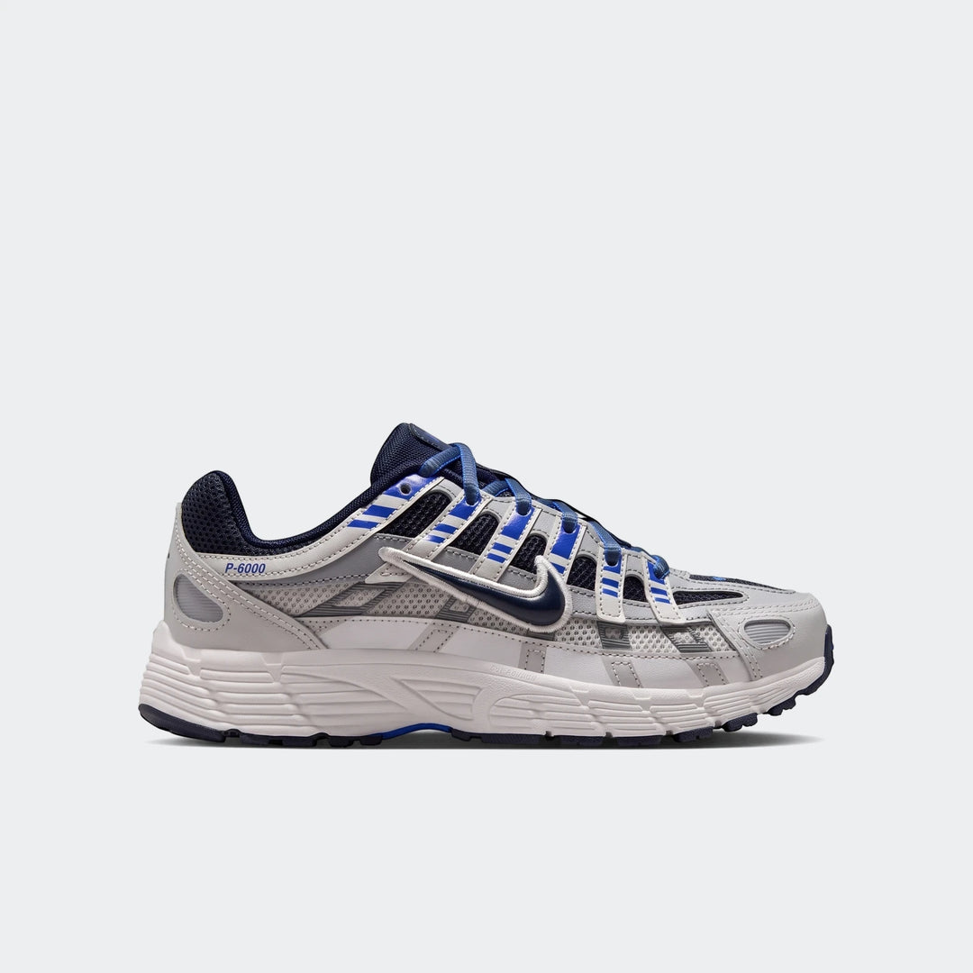 Nike P-6000 Big Kids' Shoes in gray and blue, featuring mesh and synthetic overlays, shown in a side profile view.