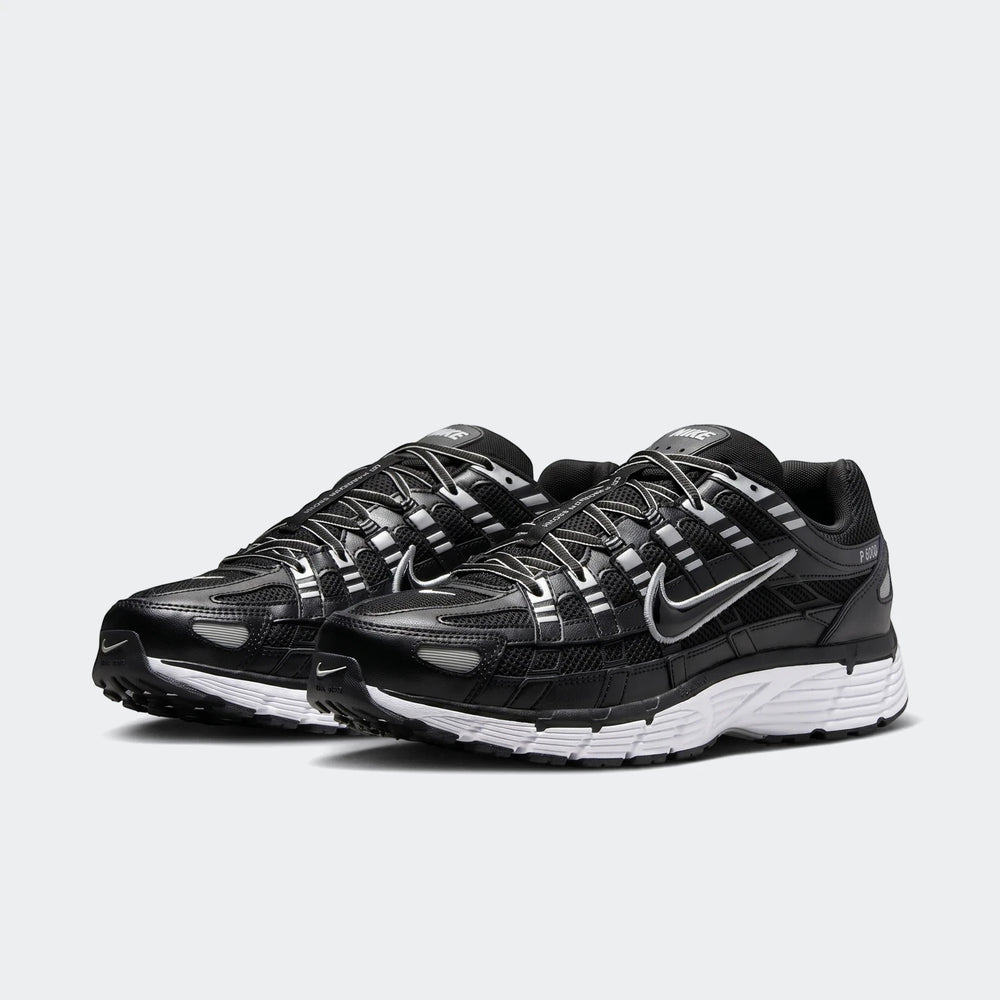 Nike P-6000 black and grey shoes with mesh upper and layered overlays, shown in side view as a pair