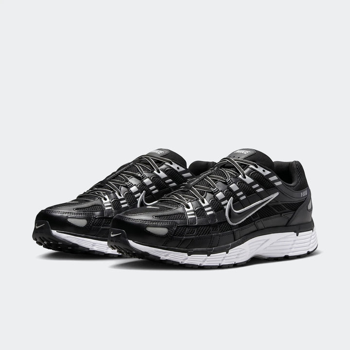 Nike P-6000 black and grey shoes with mesh upper and layered overlays, shown in side view as a pair