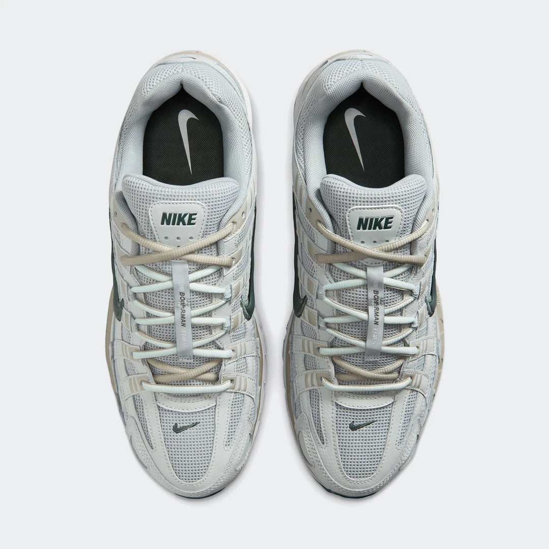 Nike P-6000 Men's Shoes in light grey and dark green, shown in a top-down flat-lay view on a white background.