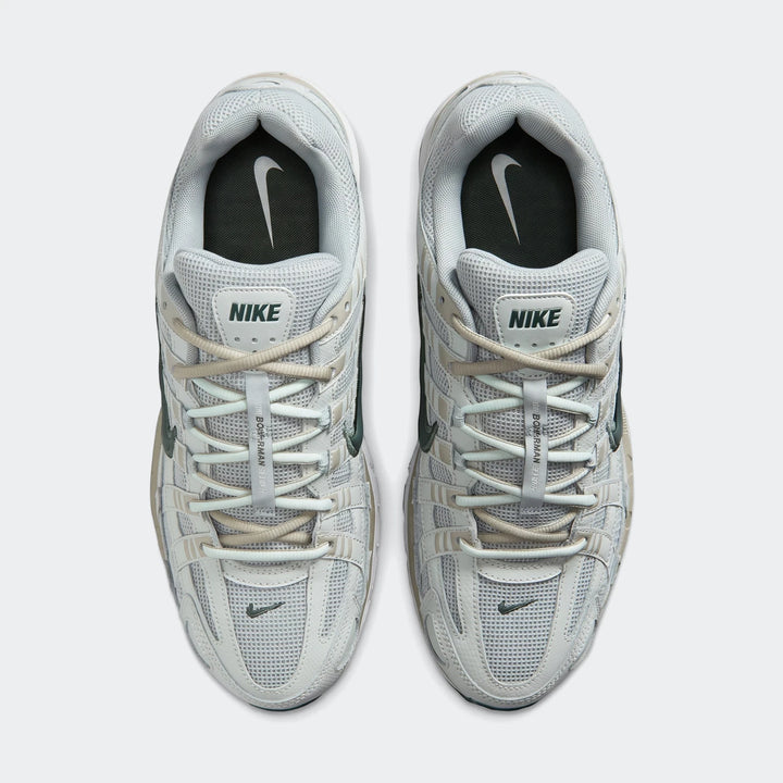 Nike P-6000 Men's Shoes in light grey and dark green, shown in a top-down flat-lay view on a white background.